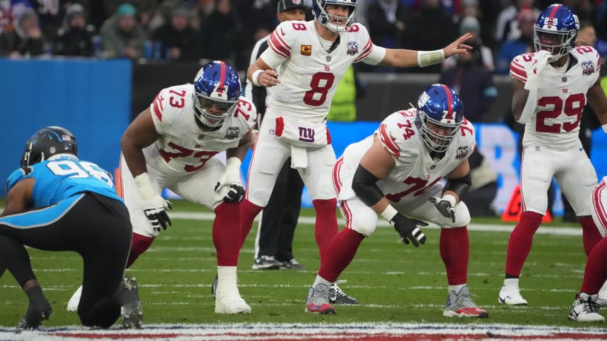 Nov 10, 2024; Munich, Germany; New York Giants quarterback Daniel Jones (8) prepares to take the snap against the Carolina Panthers in the first half during the 2024 NFL Munich Game at Allianz Arena. Mandatory Credit: Kirby Lee-Imagn Images