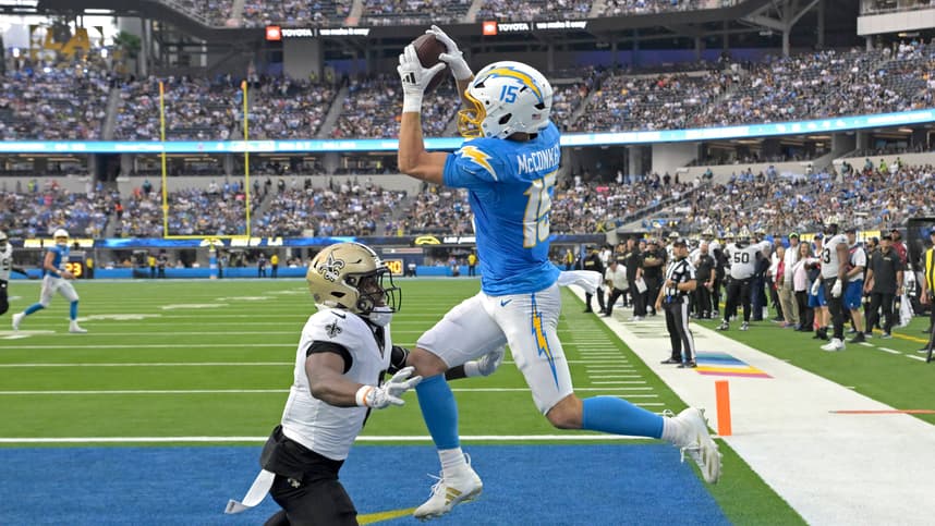 Oct 27, 2024; Inglewood, California, USA;  Los Angeles Chargers wide receiver Ladd McConkey (15) hangs on the the ball for a touchdown as he is defended by New Orleans Saints safety Ugo Amadi (0) in the second half at SoFi Stadium. Mandatory Credit: Jayne Kamin-Oncea-Imagn Images