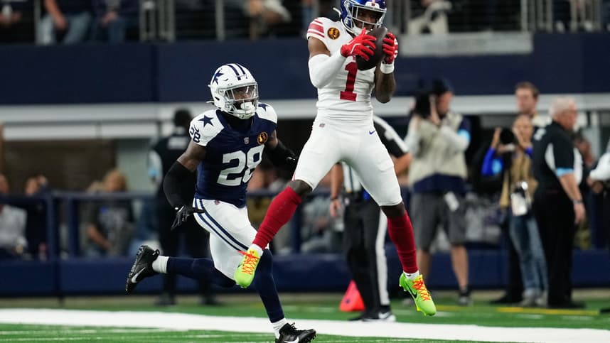 Nov 28, 2024; Arlington, Texas, USA;  New York Giants wide receiver Malik Nabers (1) catches a pass as Dallas Cowboys safety Malik Hooker (28) gives chase during the first half at AT&T Stadium. Mandatory Credit: Chris Jones-Imagn Images
