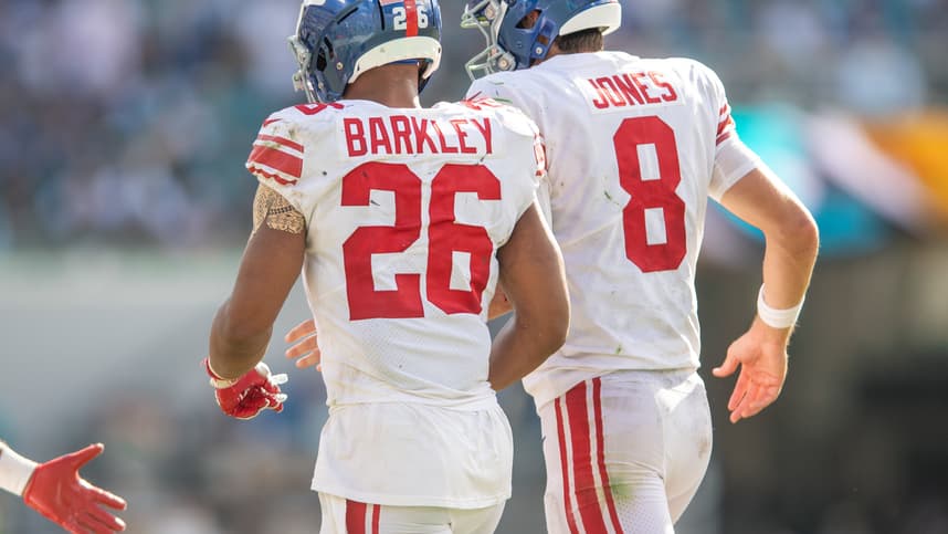 Oct 23, 2022; Jacksonville, Florida, USA; New York Giants quarterback Daniel jones (8) and running back Saquon Barkley (26) celebrate a touchdown against the Jacksonville Jaguars in the fourth quarter at TIAA Bank Field. Mandatory Credit: Jeremy Reper-Imagn Images