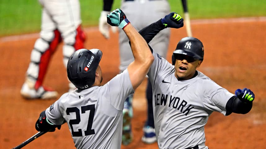 Oct 19, 2024; Cleveland, Ohio, USA; New York Yankees outfielder Juan Soto (22) celebrates with designated hitter Giancarlo Stanton (27) after hitting a three run home run during the tenth inning against the Cleveland Guardians during game five of the ALCS for the 2024 MLB playoffs at Progressive Field. Mandatory Credit: David Richard-Imagn Images