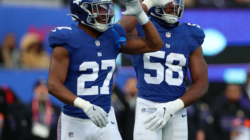 Tyler Nubin reacts with Bobby Okereke during a Giants game