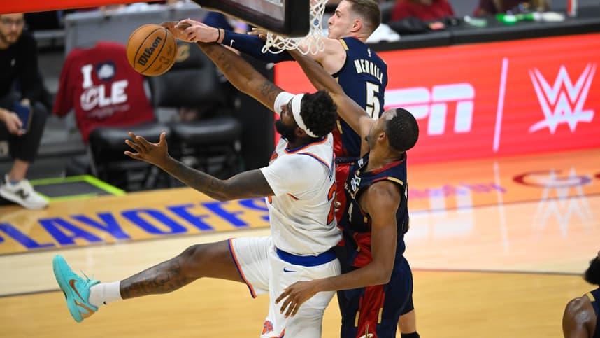 Mitchell Robinson battles for a rebound for the Knicks against the Cavaliers