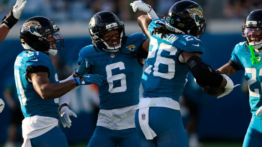 Greg Newsome II high-fives a Jaguars teammate after an interception