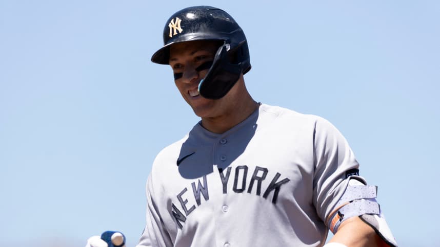 Aaron Judge smiles in the Yankees dugout against the Athletics