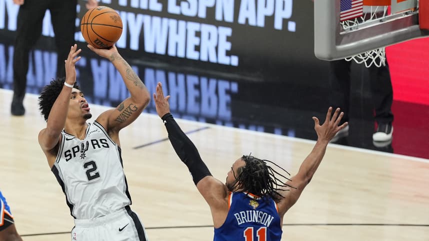 Jalen Brunson shoots over Spurs defenders during the NBA Finals