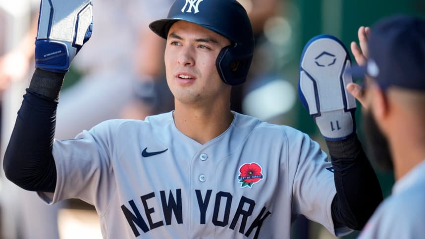 Anthony Volpe celebrates with Yankees teammates against the Royals