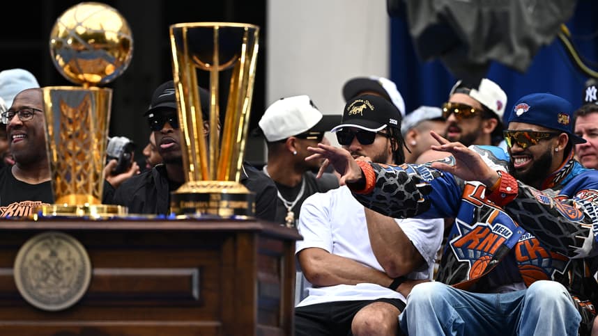 Jalen Brunson and Knicks teammates near the championship trophies