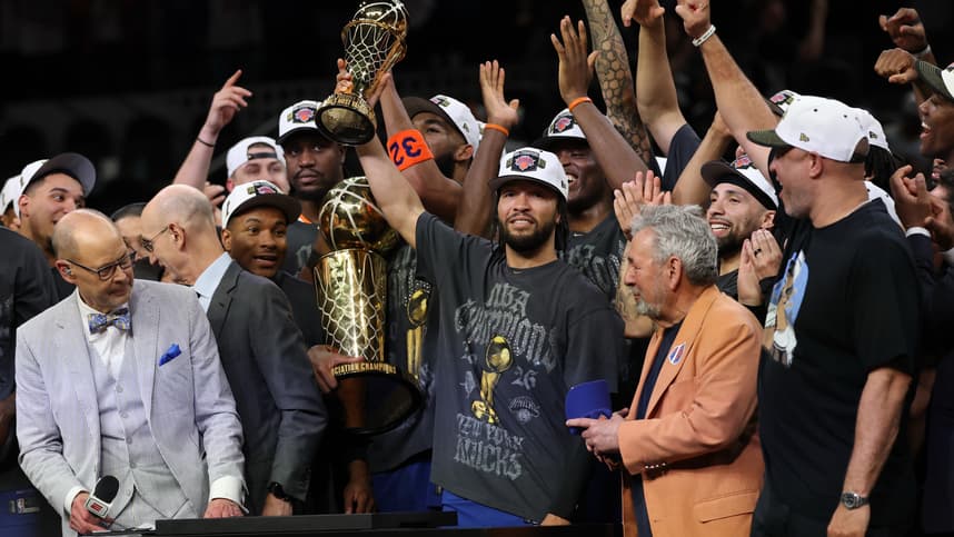 Jalen Brunson holding the Finals MVP trophy for the Knicks