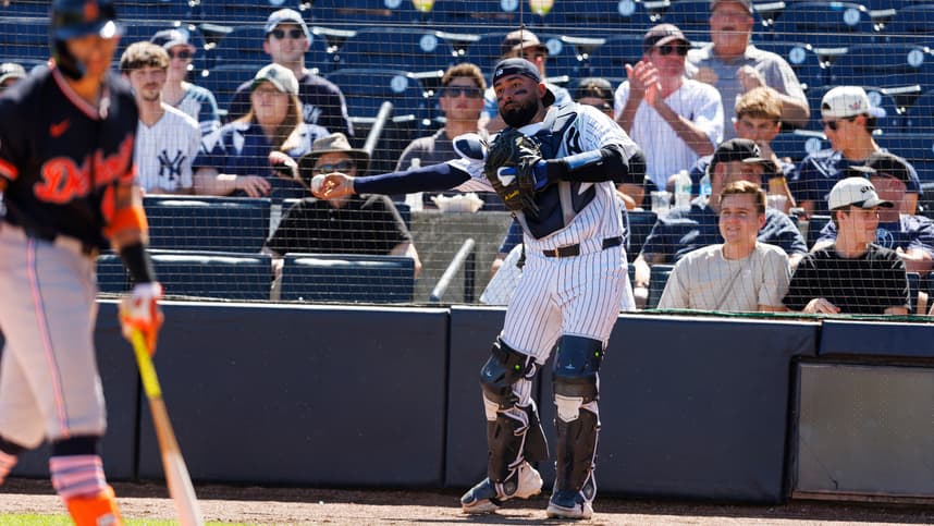 Ali Sanchez throws the ball back to the pitcher during Yankees spring training