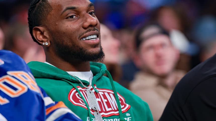 Malik Nabers sits courtside during a Knicks game in New York
