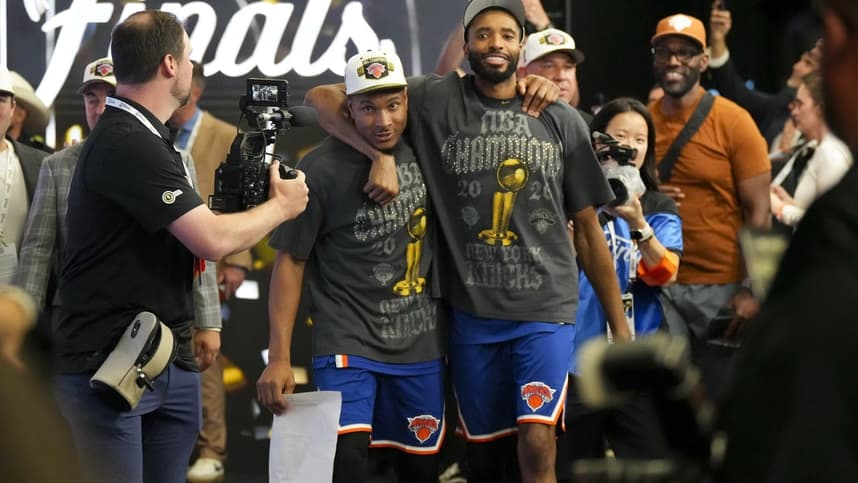Miles McBride walking off after a Knicks Finals win