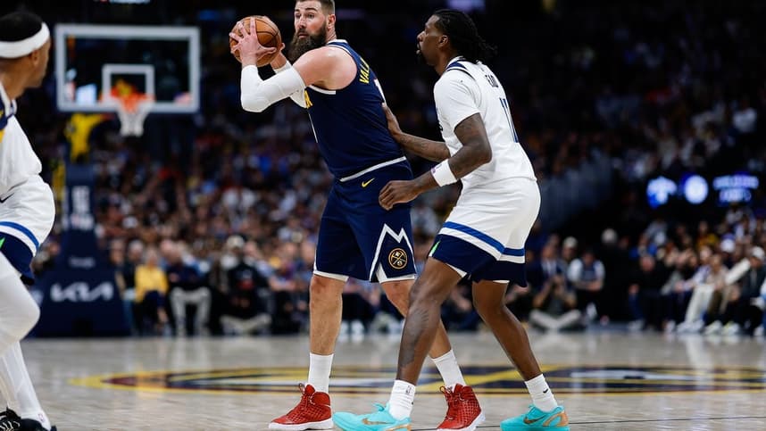 Jonas Valanciunas controls the ball during a playoff game as a Knicks option