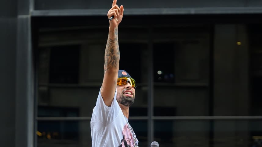 Jose Alvarado points to fans during the Knicks championship parade