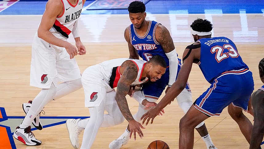 Portland Trail Blazers guard Damian Lillard (0) drives against New York Knicks center Mitchell Robinson (23) and guard Elfrid Payton (6) during the first half of an NBA basketball game, Saturday, Feb. 6, 2021, in New York