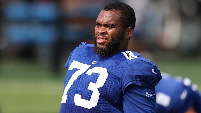 Evan Neal blocking for the Giants