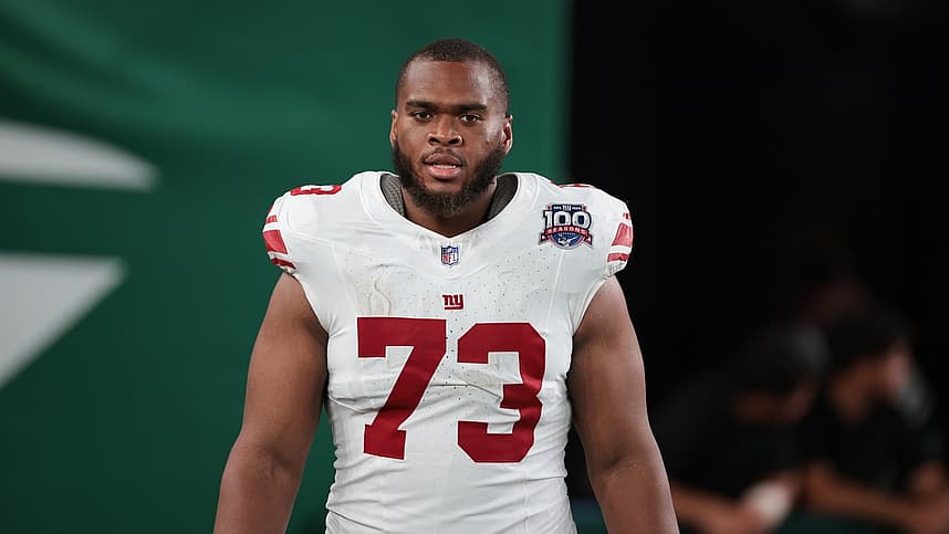 Evan Neal standing on the field after a Giants game