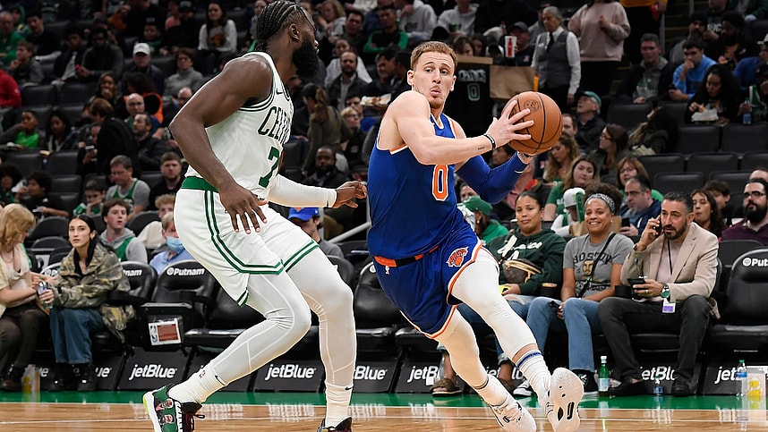New York Knicks guard Donte DiVincenzo (0) drives to the basket while Boston Celtics guard Jaylen Brown (7) defends during the second half at TD Garden