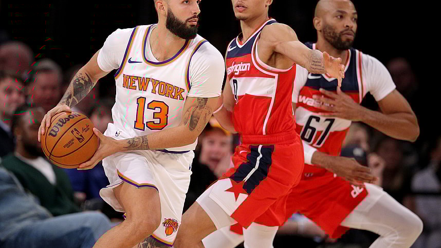 New York Knicks guard Evan Fournier (13) controls the ball against Washington Wizards guard Ryan Rollins (9) and forward Taj Gibson (67) during the fourth quarter at Madison Square Garden