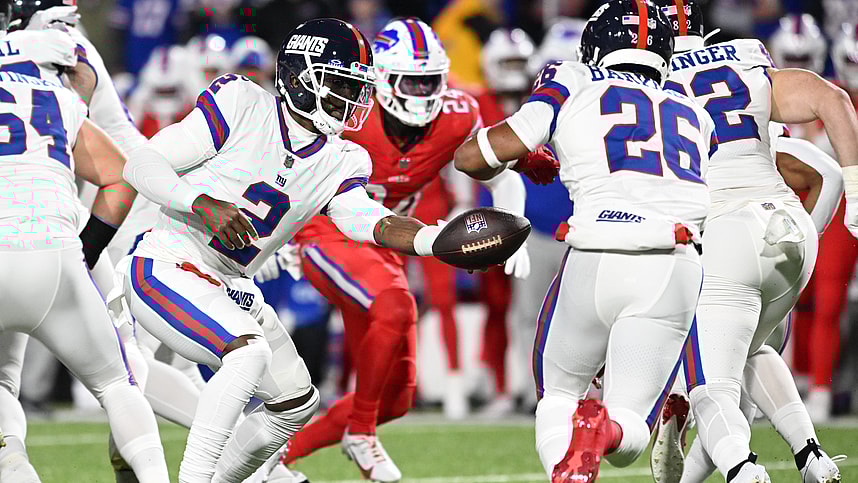 New York Giants quarterback Tyrod Taylor (2) hands off to running back Saquon Barkley (26) in the first quarter at Highmark Stadium