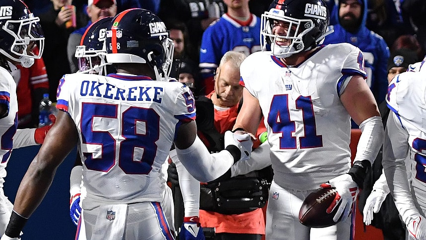 New York Giants linebacker Micah McFadden (41) celebrates with teammates (Bobby Okereke) after making an interception in the second quarter at Highmark Stadium.