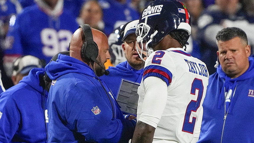 New York Giants head coach Brian Daboll speaks with New York Giants quarterback Tyrod Taylor (2) at a timeout during the first half against the Buffalo Bills at Highmark Stadium