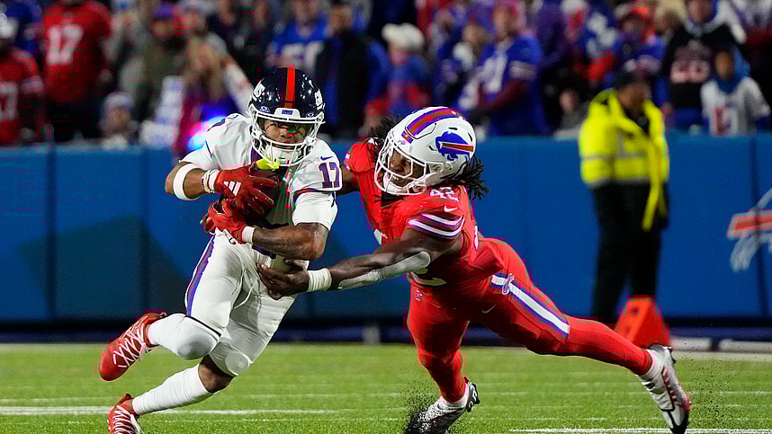 Buffalo Bills linebacker Dorian Williams (42) tackles New York Giants wide receiver Wan'Dale Robinson (17) running with the ball during the second half at Highmark Stadium