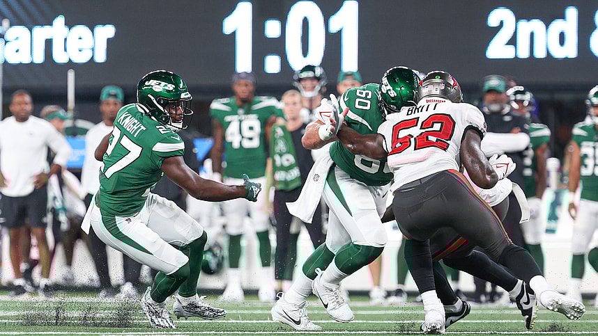 New York Jets running back Zonovan Knight (27) carries the ball as center Connor McGovern (60) blocks Tampa Bay Buccaneers linebacker K.J. Britt (52) during the first half at MetLife Stadium