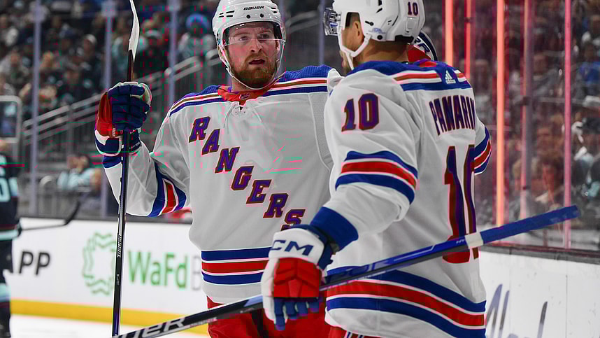 New York Rangers left wing Alexis Lafreniere (13) and left wing Artemi Panarin (10) celebrate after Panarin scored a goal against the Seattle Kraken during the first period at Climate Pledge Arena