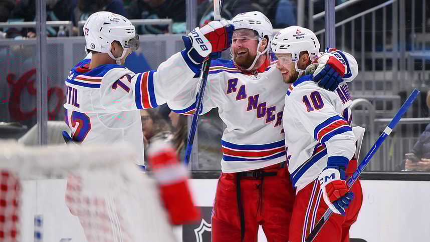 New York Rangers center Filip Chytil (72) and left wing Alexis Lafreniere (13) and left wing Artemi Panarin (10) celebrate after Panarin scored a goal against the Seattle Kraken during the third period at Climate Pledge Arena