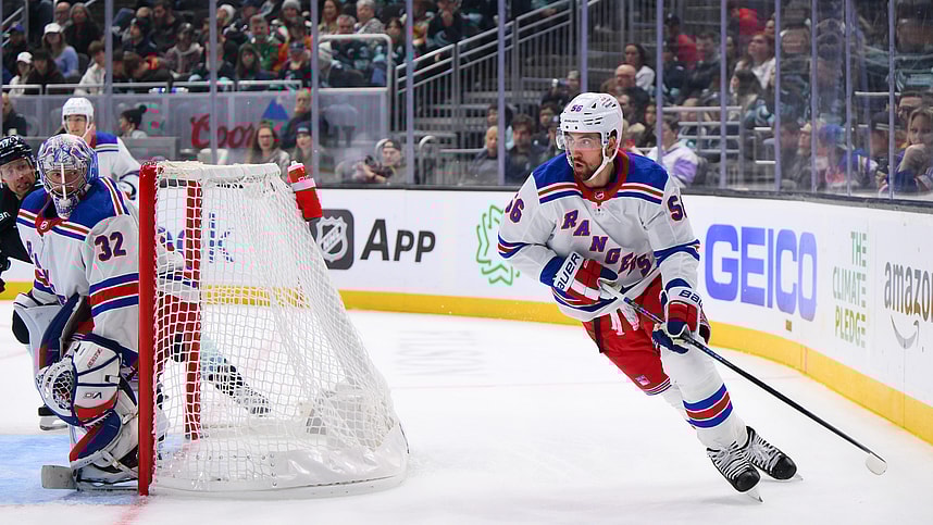 New York Rangers defenseman Erik Gustafsson (56) plays the puck behind the goal during the third period against the Seattle Kraken at Climate Pledge Arena