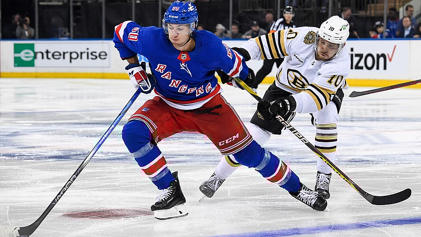 New York Rangers left wing Artemi Panarin (10) skates with the puck defended by Boston Bruins left wing A.J. Greer (10) during the third at Madison Square Garden