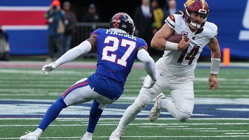 Jason Pinnock of the Giants chases Sam Howell of the Commanders in the second half. The NY Giants host the Washington Commanders at MetLife Stadium