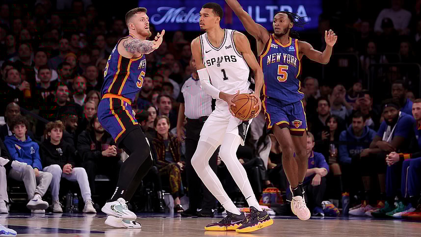 San Antonio Spurs center Victor Wembanyama (1) controls the ball against New York Knicks center Isaiah Hartenstein (55) and guard Immanuel Quickley (5) during the third quarter at Madison Square Garden