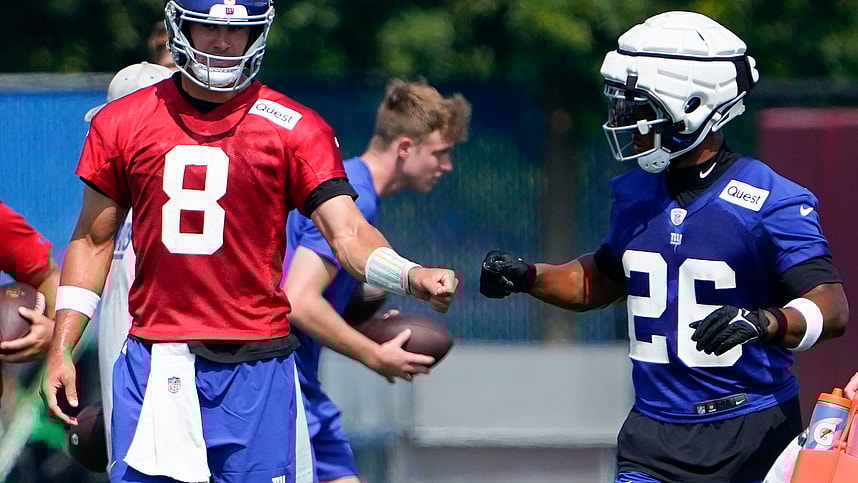 New York Giants quarterback Daniel Jones (8) and running back Saquon Barkley (26) fist-bump on the first day of training camp at the Quest Diagnostics Training Facility