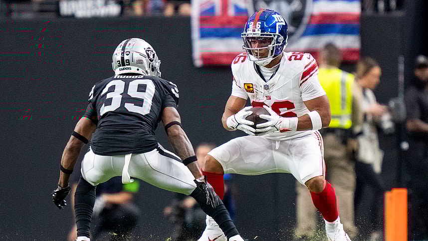 New York Giants running back Saquon Barkley (26) runs the football against Las Vegas Raiders cornerback Nate Hobbs (39) during the first quarter at Allegiant Stadium