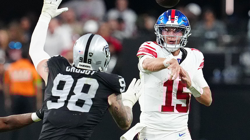 New York Giants quarterback Tommy DeVito (15) is pressured by Las Vegas Raiders defensive end Maxx Crosby (98) during the fourth quarter at Allegiant Stadium