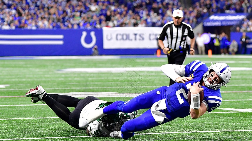 Indianapolis Colts quarterback Carson Wentz (2) is tackled short of the end zone by New York Jets defensive end Shaq Lawson (50) during the second half at Lucas Oil Stadium