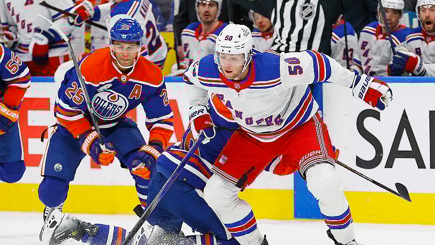 New York Rangers forward Will Cuylle (5) moves the puck around Edmonton Oilers forward Connor Brown (28) and defensemen Darnell Nurse (25) during the second period at Rogers Place
