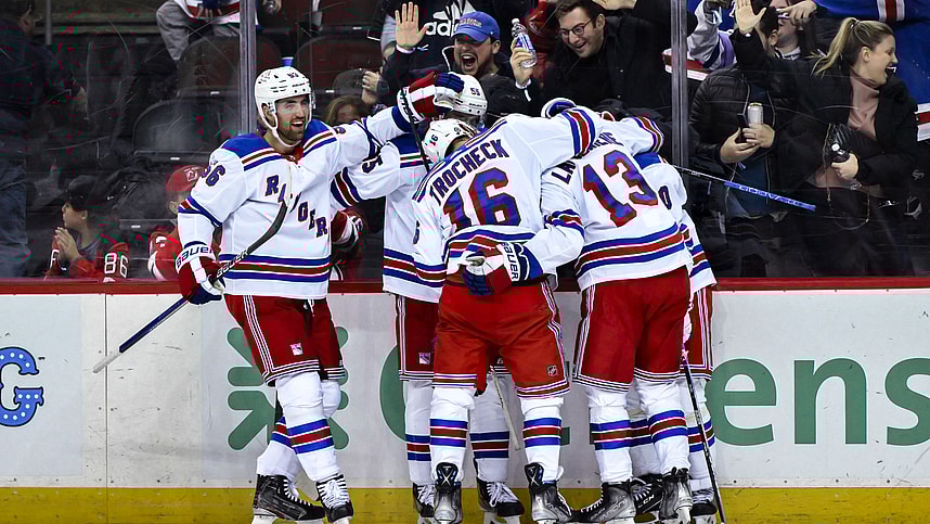 New York Rangers left wing Artemi Panarin (10) celebrates with teammates after scoring a goal against the New Jersey Devils during the third period at Prudential Center