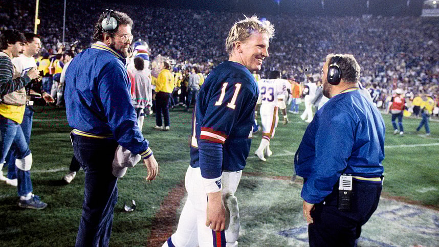 New York Giants quarterback Phil Simms (11) celebrates after defeating the Denver Broncos in Super Bowl XXI at the Rose Bowl. The Giants defeated the Broncos 39-20