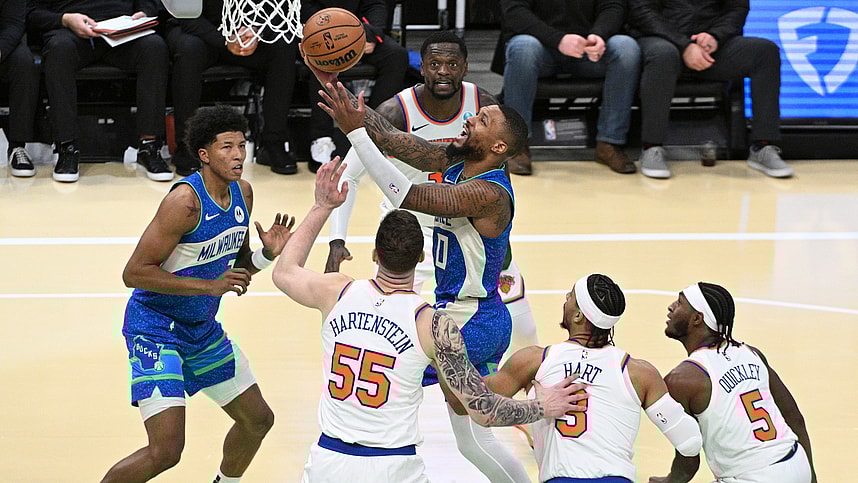 Milwaukee Bucks guard Damian Lillard (0) drives to the basket against New York Knicks defenders in the second half at Fiserv Forum