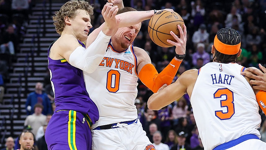 New York Knicks guard Donte DiVincenzo (0) is fouled by Utah Jazz forward Lauri Markkanen (23) during an inbound pass in the last few seconds of the game at Delta Center