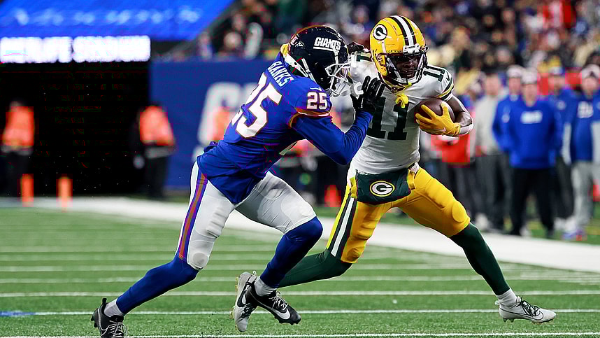 Green Bay Packers wide receiver Jayden Reed (11) runs the ball after a catch against New York Giants cornerback Deonte Banks (25) during the fourth quarter at MetLife Stadium