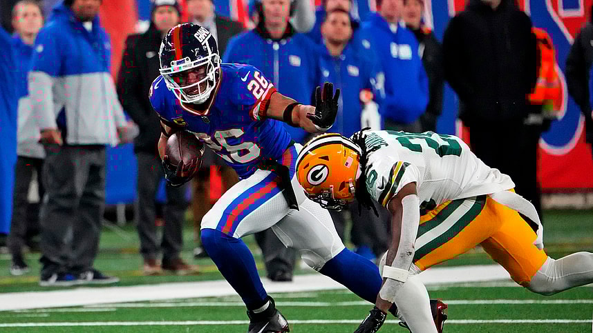 New York Giants running back Saquon Barkley (26) runs the ball against Green Bay Packers safety Darnell Savage (26) during the fourth quarter at MetLife Stadium