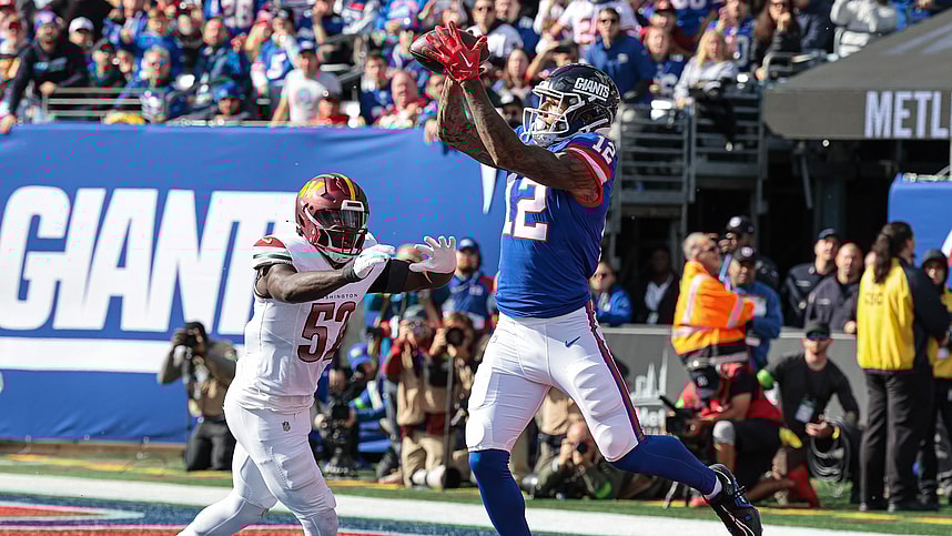 New York Giants tight end Darren Waller (12) catches a touchdown pass during the first half in front of Washington Commanders linebacker Jamin Davis (52) at MetLife Stadium