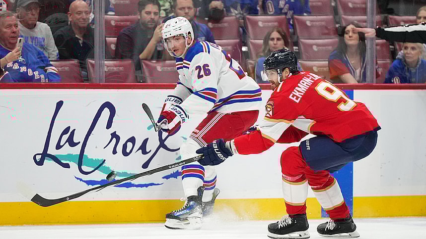 New York Rangers left wing Jimmy Vesey (26) passes the puck away from Florida Panthers defenseman Oliver Ekman-Larsson (91) during the first period at Amerant Bank Arena