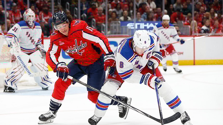 New York Rangers defenseman Jacob Trouba (8) skates with the puck as Washington Capitals left wing Sonny Milano (15) defends during the first period at Capital One Arena