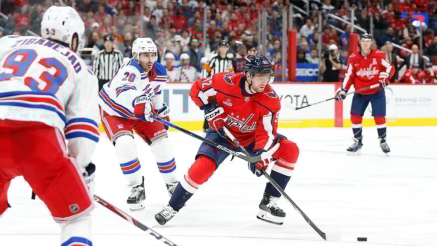 Washington Capitals center Evgeny Kuznetsov (92) skates with the puck as New York Rangers left wing Chris Kreider (20) defends during the third period at Capital One Arena