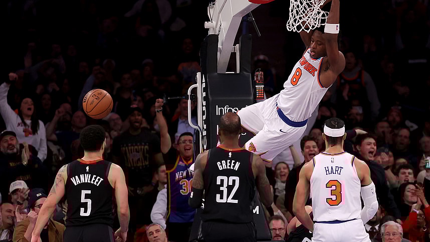 New York Knicks forward OG Anunoby (8) hangs on the rim after a dunk against Houston Rockets guard Fred VanVleet (5) and forward Jeff Green (32) during the fourth quarter at Madison Square Garden